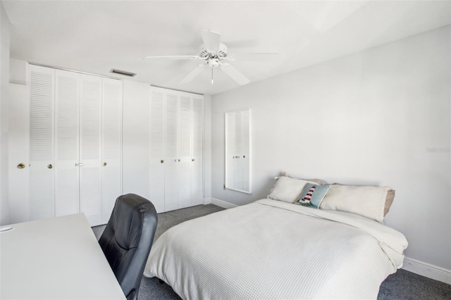 bedroom featuring ceiling fan, carpet flooring, and two closets