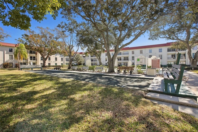 view of property's community with a lawn