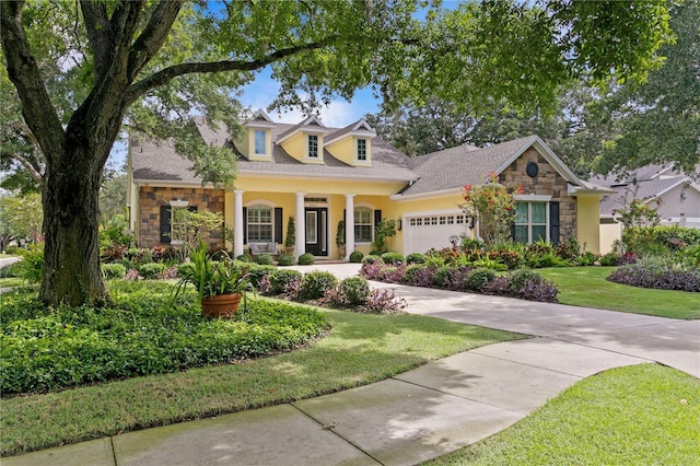 cape cod house with a garage and a front yard