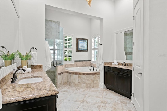 bathroom featuring vanity and shower with separate bathtub