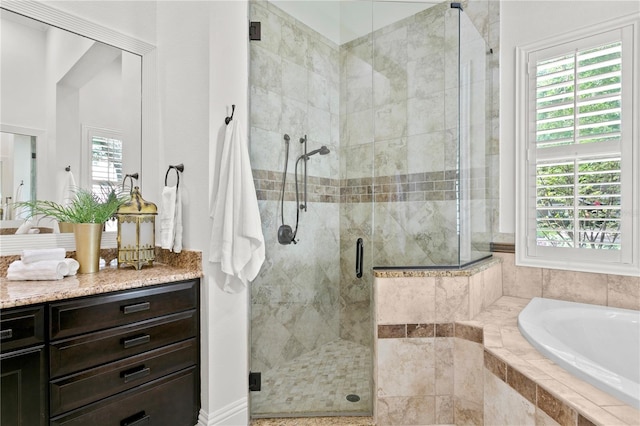 bathroom with a wealth of natural light and shower with separate bathtub