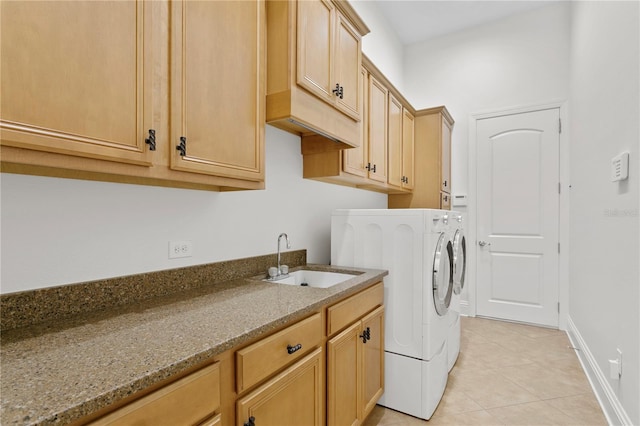 washroom with cabinets, washing machine and dryer, sink, and light tile patterned flooring