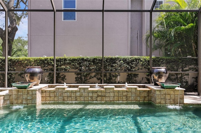 view of pool featuring pool water feature and a lanai