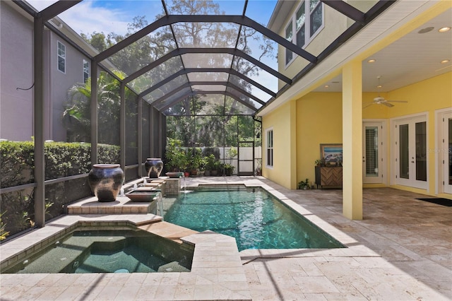 view of pool featuring french doors, a lanai, an in ground hot tub, ceiling fan, and a patio