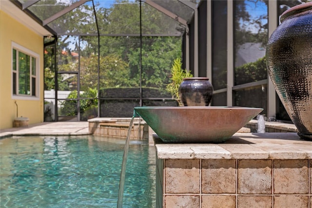 view of pool featuring a lanai and pool water feature