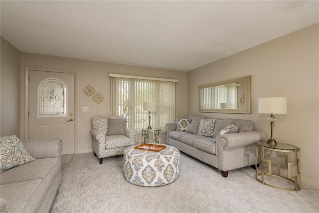 carpeted living room featuring a textured ceiling