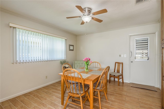 dining area featuring crown molding, ceiling fan, and a healthy amount of sunlight