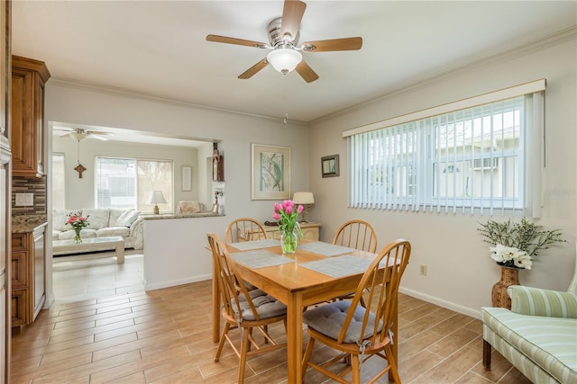 dining room with ornamental molding and ceiling fan