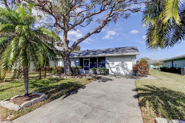 ranch-style house with a garage and a front lawn