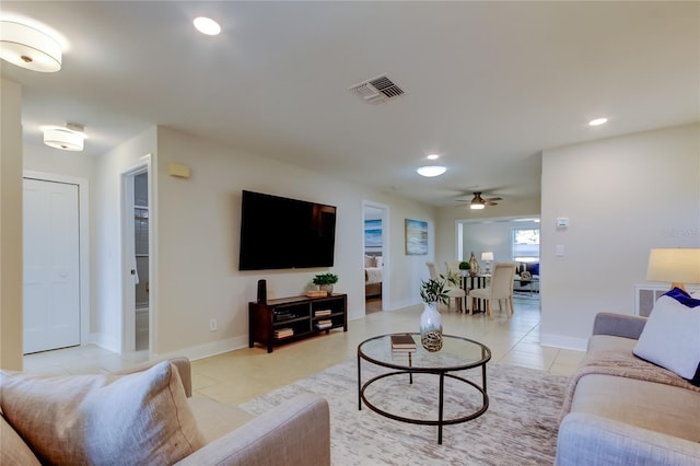 living room with ceiling fan and light tile patterned flooring