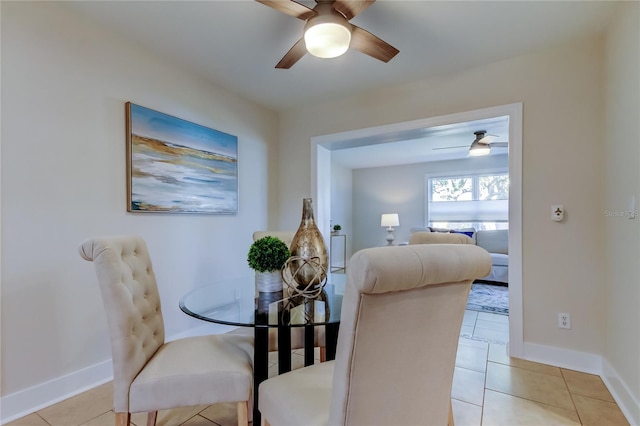 tiled dining space featuring ceiling fan