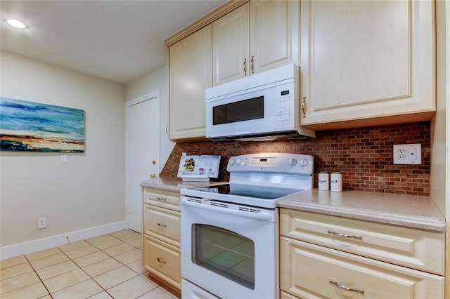 kitchen with tasteful backsplash, light tile patterned floors, white appliances, and cream cabinetry