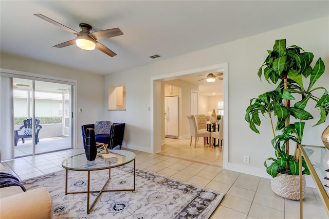 living room featuring light tile patterned floors and ceiling fan