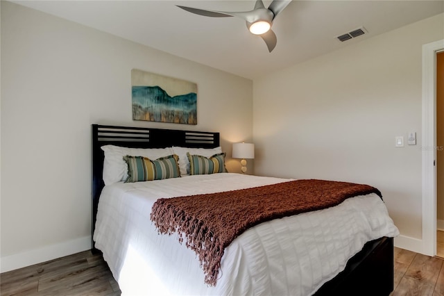 bedroom with hardwood / wood-style flooring and ceiling fan