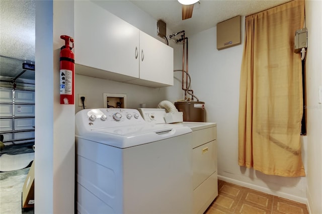 laundry room featuring cabinets, independent washer and dryer, and gas water heater