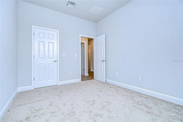 unfurnished bedroom featuring light colored carpet