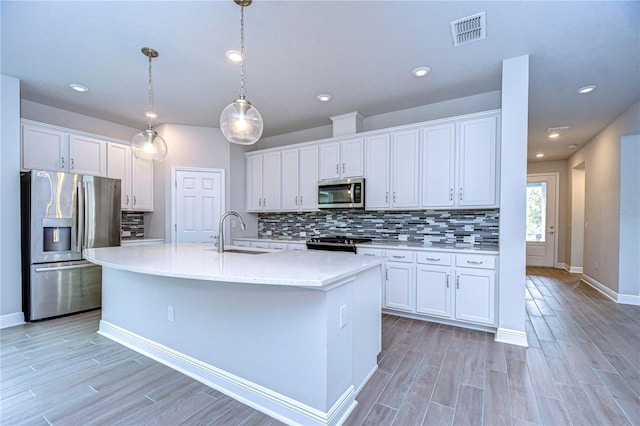 kitchen with stainless steel appliances, sink, and white cabinets