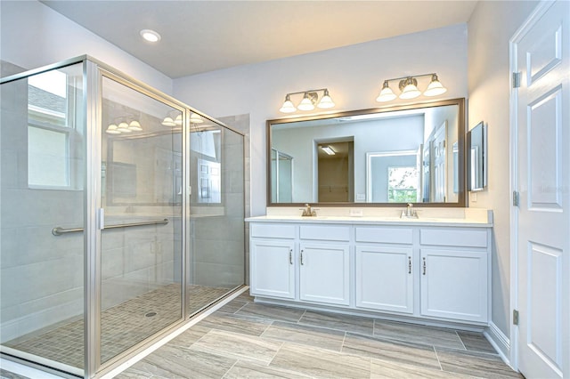 bathroom with walk in shower and vanity