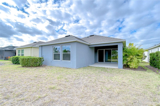 back of property featuring a yard and a patio area