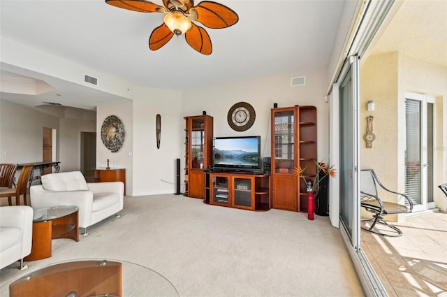 living room with light colored carpet and ceiling fan