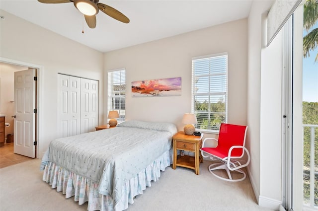 bedroom with light colored carpet, a closet, and ceiling fan