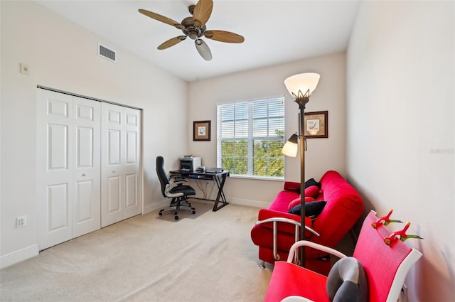 office space with light colored carpet and ceiling fan