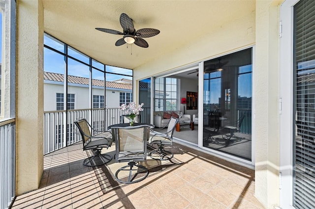 sunroom featuring ceiling fan