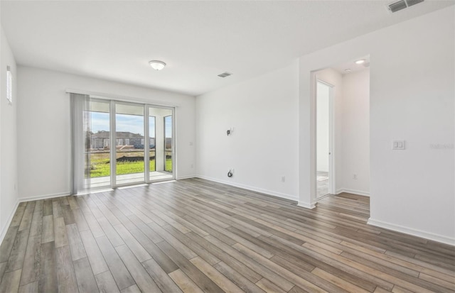 spare room with hardwood / wood-style floors