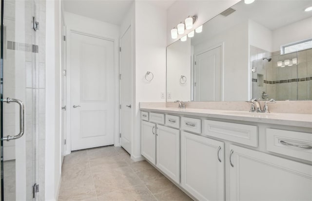 bathroom featuring an enclosed shower, vanity, and tile patterned flooring