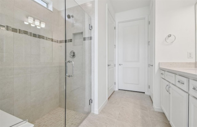 bathroom featuring vanity and an enclosed shower