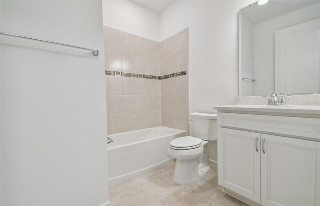 full bathroom with tiled shower / bath, vanity, and toilet