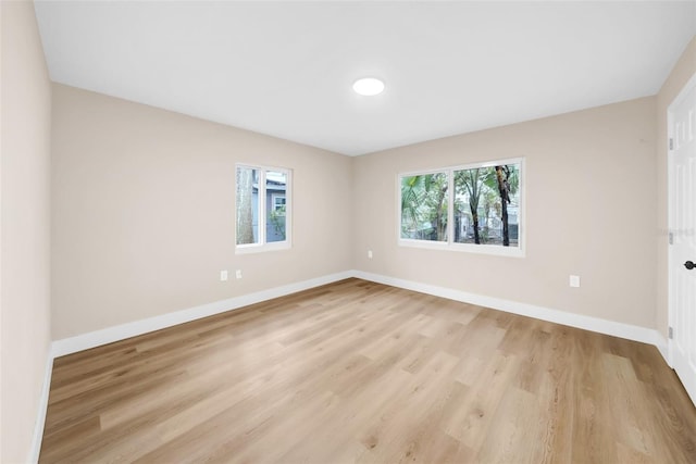 unfurnished room featuring a healthy amount of sunlight and light wood-type flooring