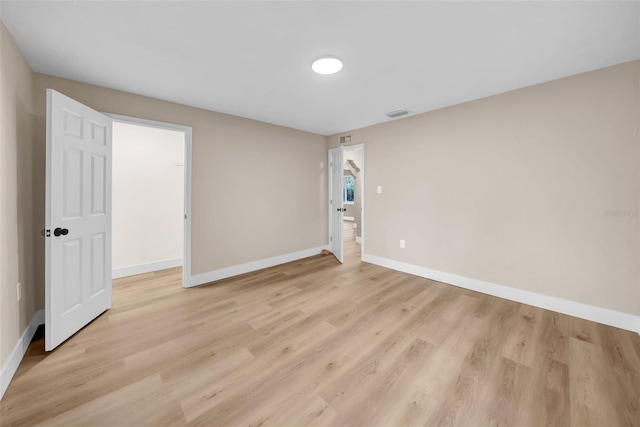 empty room with light hardwood / wood-style floors