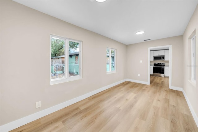 unfurnished living room with light wood-type flooring