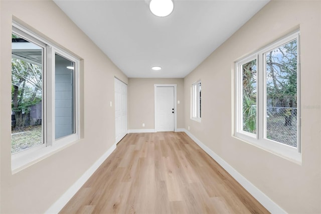 corridor with light wood-type flooring