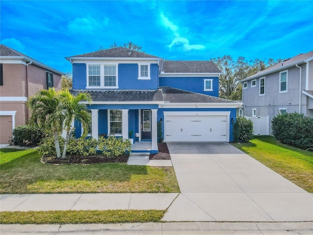 view of property with a garage, a front lawn, and a porch