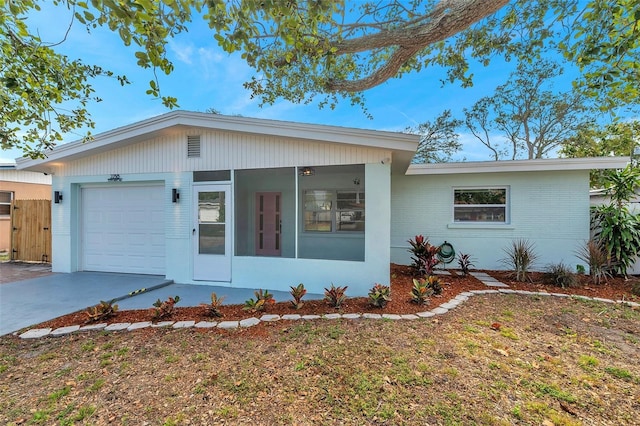 view of front of house with a garage and a sunroom