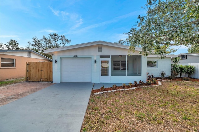 single story home with a garage and a front yard