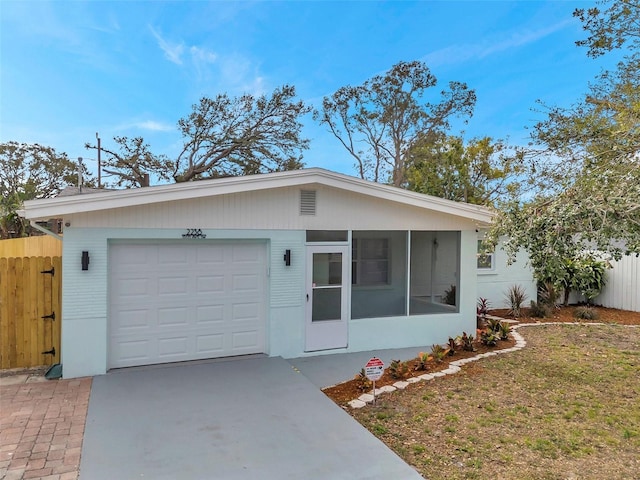 ranch-style house with a garage and a front lawn