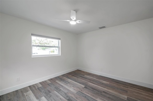 unfurnished room featuring dark wood-type flooring and ceiling fan