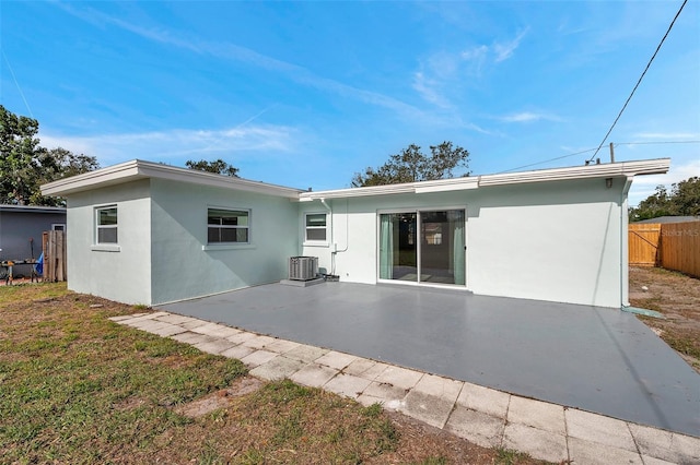 back of property with a patio, cooling unit, and a lawn