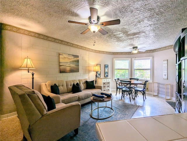 living room featuring ceiling fan and a textured ceiling