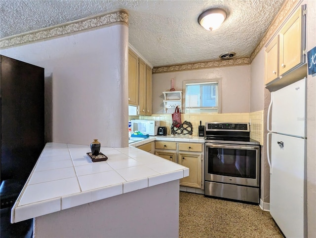 kitchen featuring white appliances, backsplash, a textured ceiling, tile countertops, and kitchen peninsula