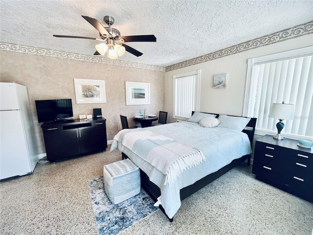 bedroom featuring ceiling fan, white fridge, and a textured ceiling