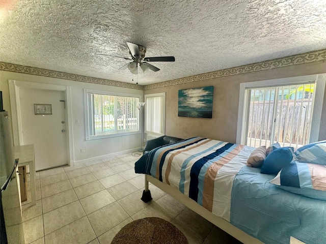 tiled bedroom with ceiling fan and a textured ceiling