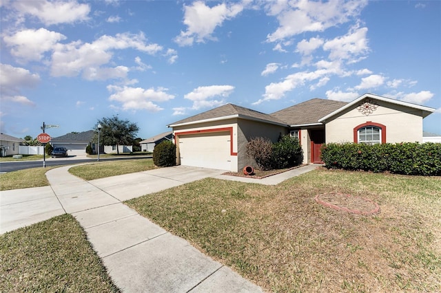 single story home with a garage and a front lawn