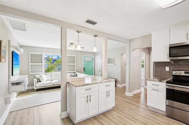 kitchen with visible vents, appliances with stainless steel finishes, and white cabinets