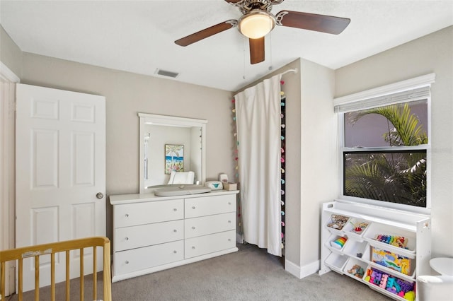 bedroom featuring light carpet, ceiling fan, visible vents, and baseboards