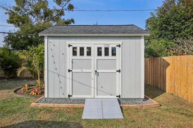 view of shed featuring fence