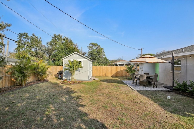 view of yard featuring a shed, a patio, a fenced backyard, and an outdoor structure